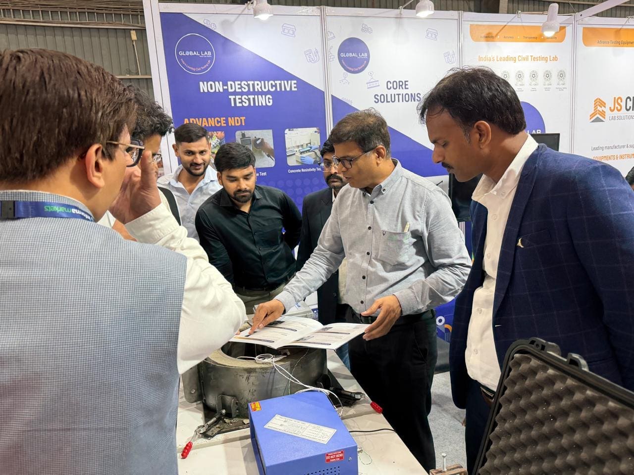 Global Lab team with industry visitors at World of Concrete India 2026 Booth B83